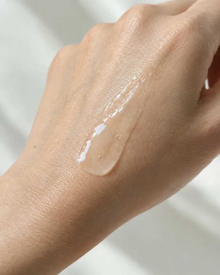Close-up of clear skincare serum swatched on the back of a hand